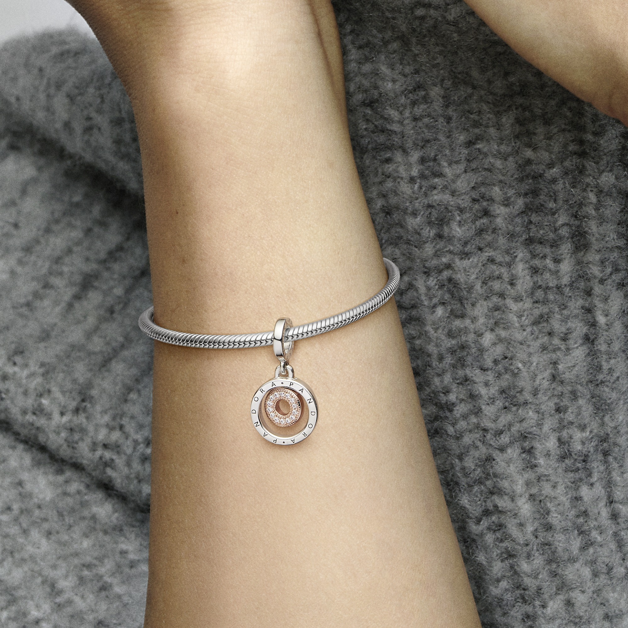 Pandora logo sterling siler and 14k rose gold-plated dangle with clear cubic zirconia