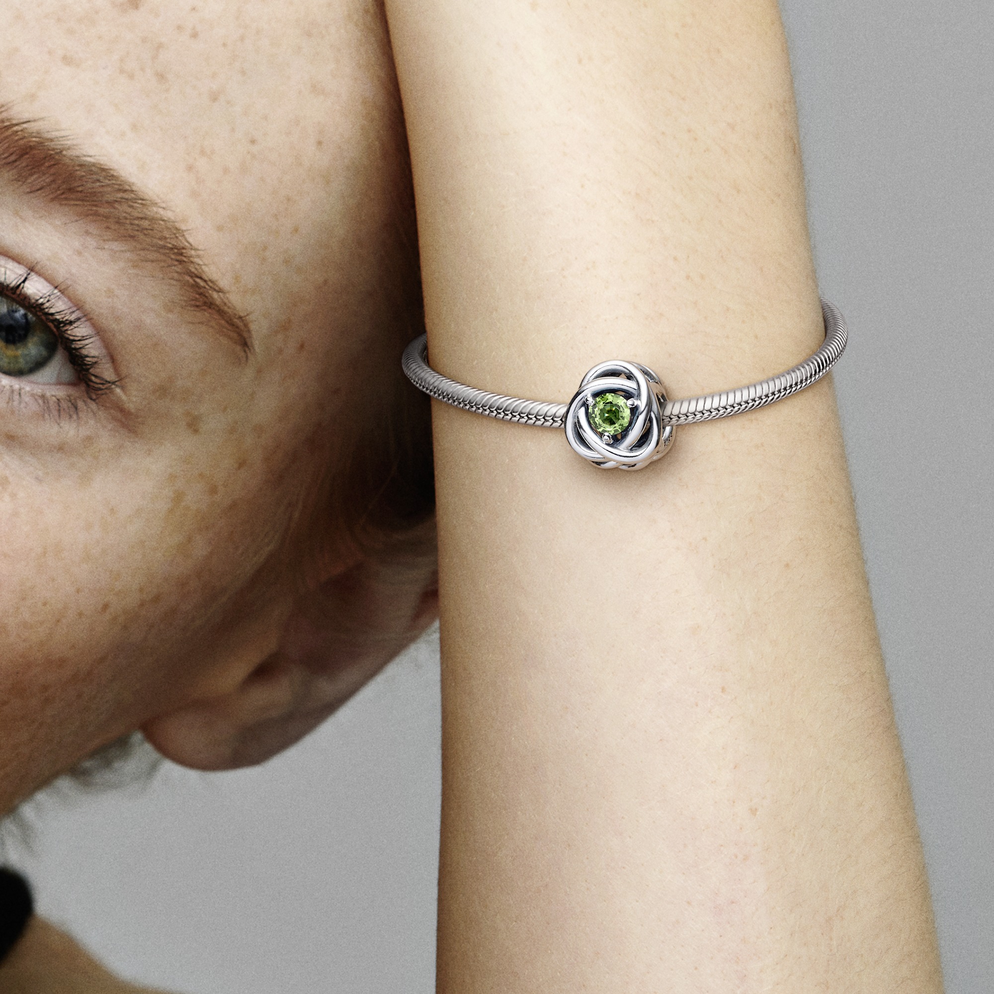 Sterling silver charm with spring green crystal
